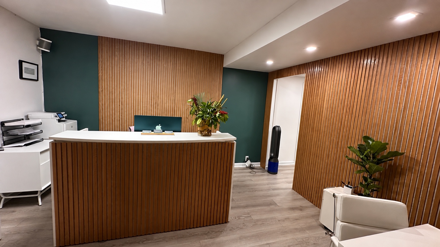 Finished commercial office reception remodel with wood slat wall